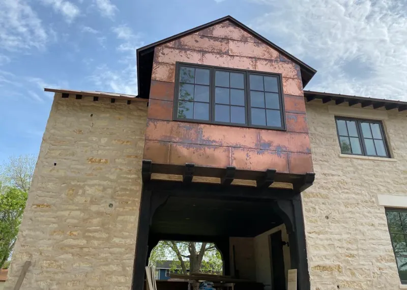 Copper metal panel facade on a stone building for Skylight Installation in Riverview